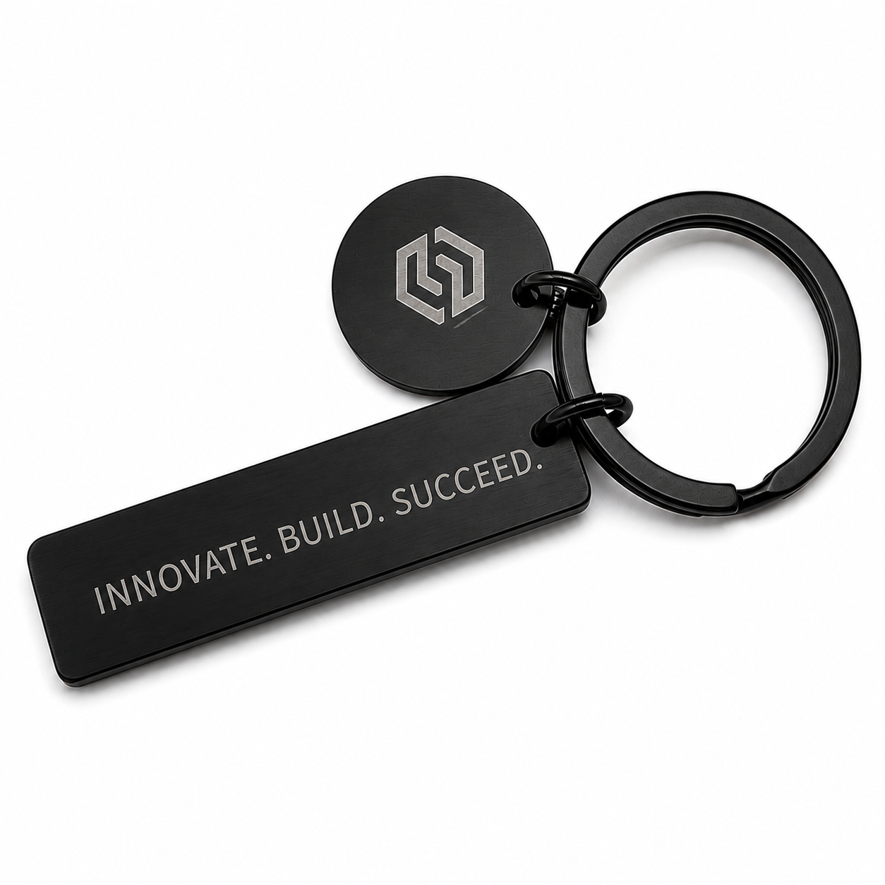 Custom engraved black metal keychain with company logo and motivational quote on a rectangular tag