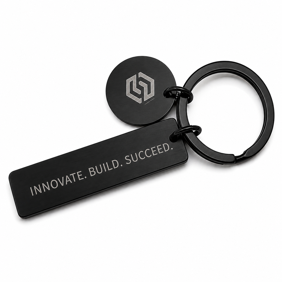 Custom engraved black metal keychain with company logo and motivational quote on a rectangular tag